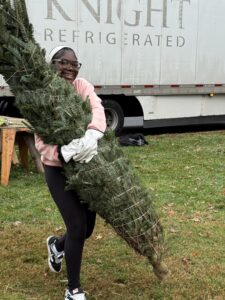 Teen girl volunteers at the lot.